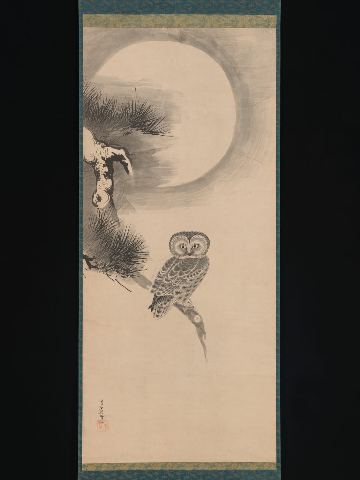 An owl in ink, perched on a pine branch beneath a pale full moon, on a hanging scroll.